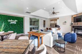A modern living room with a wooden dining table and white chairs.