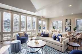 A living room with a couch, chairs, and a coffee table.