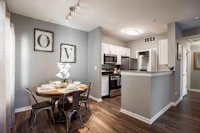 A kitchen with a dining table set for four.