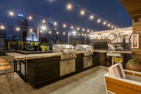 DTLA, CA Apartments - Santa Fe Lofts - Grill Area with BBQs, Extra Countertop Space, Cafe Lights, Barstools, and Lounge Seating