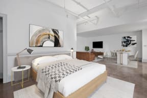 a bedroom with a bed and a desk in a room