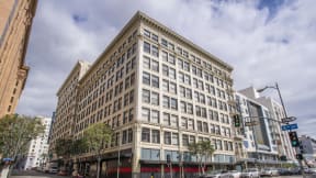 a large white building with many windows and a red awning