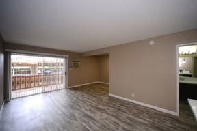 an empty living room with a sliding glass door