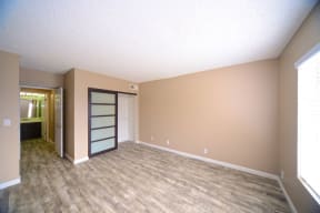 Two BR Apartments in Chatsworth CA - Waterstone - Large Bedroom with Wood-Style Flooring, Sliding Door Closet, and Large Window