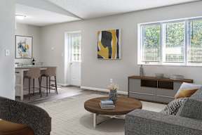 A living room with a grey couch, a brown coffee table, and a painting on the wall.