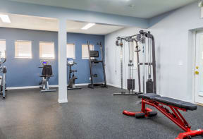 a gym with exercise equipment and weights at the flats
