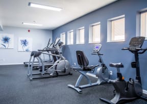 a gym with various exercise equipment in a building