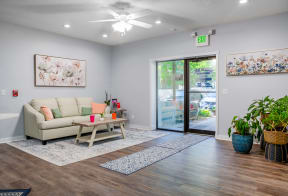 a living room with a couch and a door to a patio
