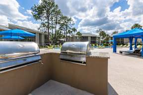 A sunny day at the outdoor pool area with blue umbrellas and loungers.