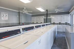 A row of washing machines in a laundromat.