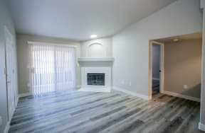 an empty living room with a fireplace