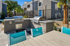 an outdoor kitchen with a grill and a bbq