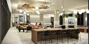 A modern office space with a reception desk and seating area.