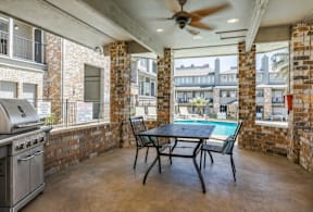 A patio with a table and chairs and a pool table.