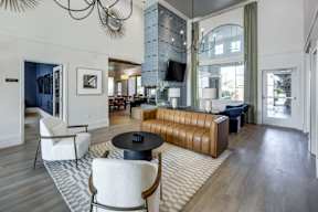 A modern living room with a white chair and a brown sofa.