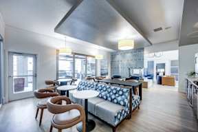A modern dining area with a table and chairs.