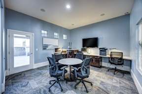 A conference room with a white table and chairs.