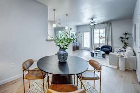 A dining room with a round table and chairs.