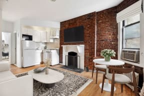 a living room with a brick wall and a fireplace