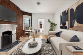 a living room with a white couch and a fireplace