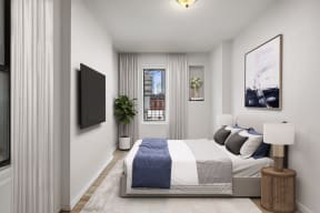 a bedroom with a bed and a window in a 555 waverly unit