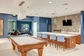 Clubhouse Common Area & Kitchen with Bar Seating, TV, and Billiards Table
