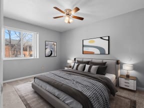 a bedroom with a large bed and a ceiling fan