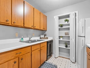 apartment kitchen with wood cabinets