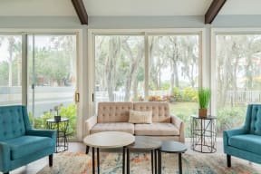 a living room filled with furniture and a large window