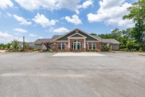an empty parking lot in front of a house