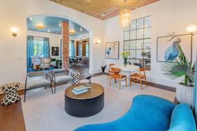 A living room with a blue couch and a coffee table.