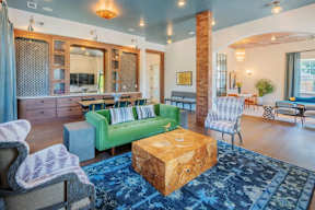 A living room with a green couch and a wooden coffee table.