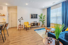 A living room with a yellow chair and a blue couch.