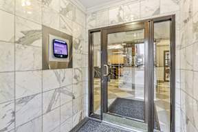 A glass door with a sign on the wall.