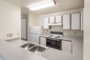 a kitchen with white cabinetry and white appliances