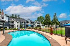 a swimming pool with houses in the background