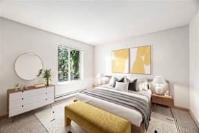 A bedroom with a bed, nightstands, and a window.