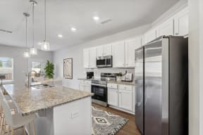 a kitchen with stainless steel appliances and a granite counter top