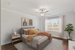 a bedroom with a bed and a ceiling fan
