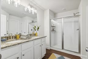 a white bathroom with a shower and a sink