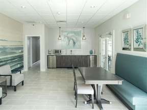 A dining room with a table and chairs.