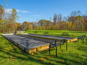 A playground with a slide and swings in a park.