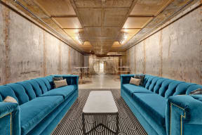 a room with blue couches and a coffee table at Metro67, Memphis