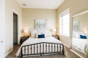 a bedroom with a large bed and a large mirror at Metro67, Memphis, TN
