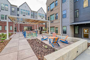 A modern building with a patio and benches.
