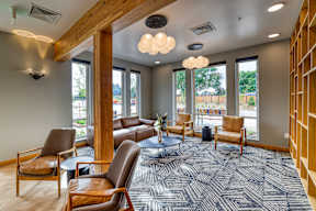 A spacious waiting room with brown leather chairs and a patterned carpet.