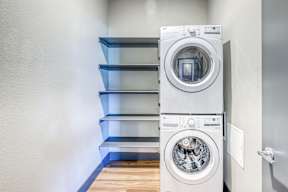 A modern washing machine is placed in a laundry room.