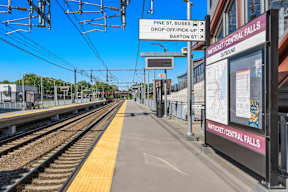 A train station with a sign that says Pine St. Buses drop-off/pick-up.