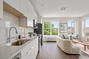 A modern kitchen with a white and wood color scheme.