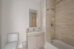 A white toilet sits next to a sink in a bathroom.